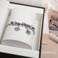 Pulsera de acero inoxidable con dijes de corazón y trébol